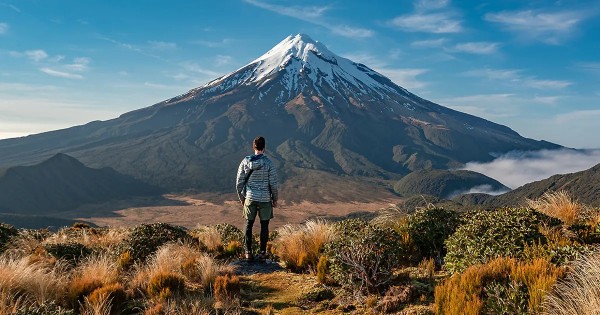 Man standing in awe of Mt Taranaki / Te Papakura o Taranaki